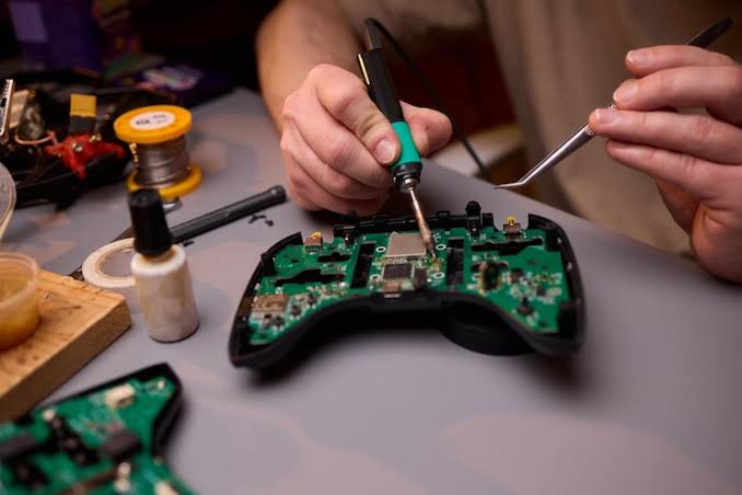 Gaming console repair specialist testing